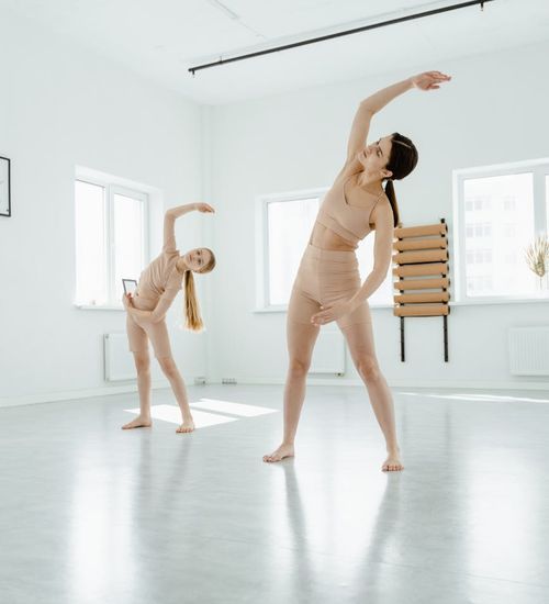 A person feeling energized and stretching in a bright, open space.